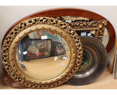 Two gilt framed wall mirrors, circular and rectangular; together with a mahogany framed oval wall mirror, a pair of metal Tra