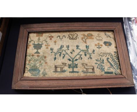 An early 19th Century sampler, linen ground with cross stitch animals, birds, trees and foliage, cut down and loose in a late