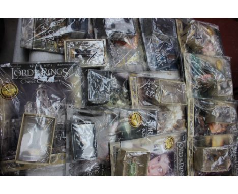 A collection of unopened Lord of The Rings memorabilia, chess set, figures, games, etc