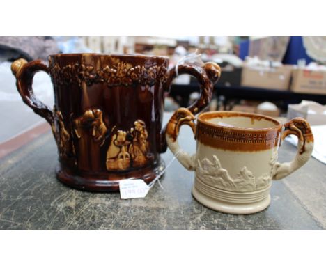 An unusual Treacle glazed large Staffordshire late 18th early 19th Century 'Loving Cup' applied dog fights with two frogs to 