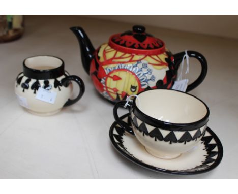 A Moorcroft trial pattern, the Mad Teaset, comprising teapot and cover, and cream jug, together with cup and saucer, in Spade