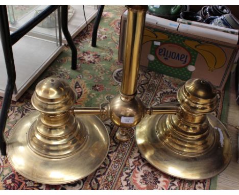 A large brass chandelier with central column and two large diffusing lights in an architectural/industrial style 