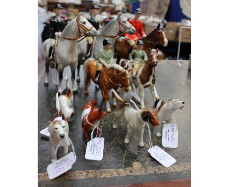 A Beswick hunting group, huntsman, two hunts women, boy and girl, fox and four hounds (damage to one of horse's legs and boy'