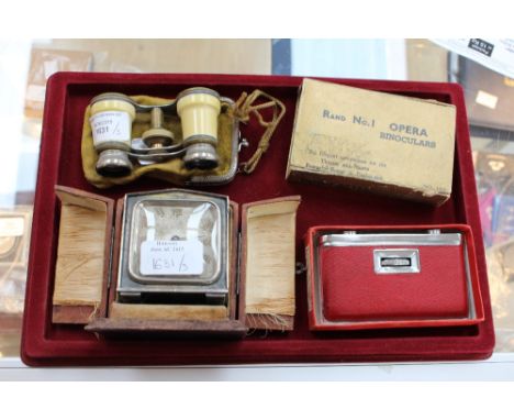 A circa 1920s French travel alarm clock in case and two pairs of opera glasses (3)  