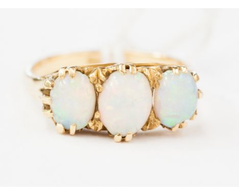 An 18ct gold and opal three-stone ring,  size M