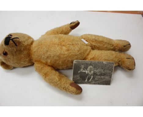 A 1940 Chad Valley teddy bear, growler not working with picture of original owner 