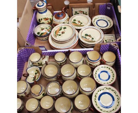 A large collection of Torquay ware depicting cottages and inscribed with mottos, comprising coffee pot, teapot, cups, saucers