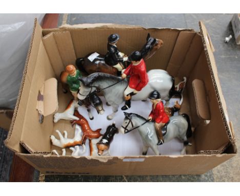 A set of Beswick hunting hounds and fox; together with Beswick hunts woman and other hunting figures 