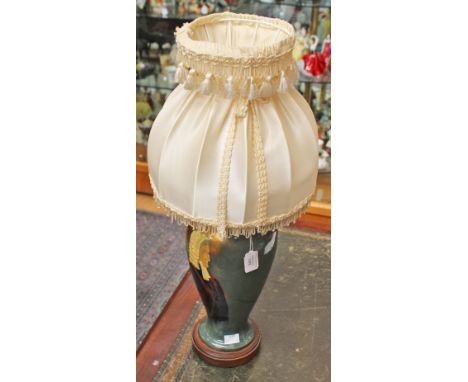 A hand painted table lamp, the lamp base depicting a profile view of a judge, of inverted baluster, two handled form, signed 