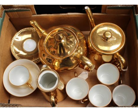 A Royal Winton 'Grimwades' teapot; together with a part set of Royal Worcester gilt tea set, with teapot, water jug, sugar bo