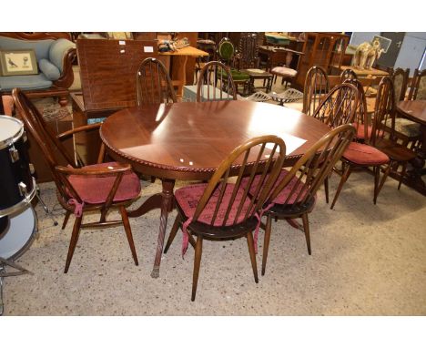 Set of ten Ercol dark wood stick back dining chairs together with a unrelated twin pedestal dining table