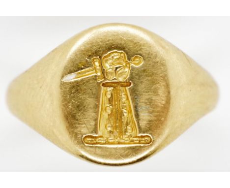 18ct gold signet ring. Seal engraved with a cubit arm erect in armor, the hand holding a dagger downward. Approx 3.45 grams t
