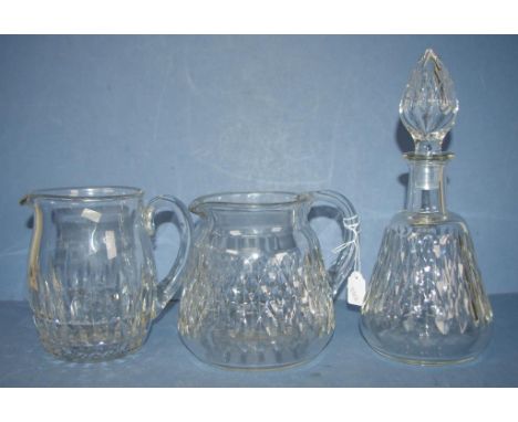 Three various Baccarat crystal tableware items including decanter, (height 28cm approx); and 2 various water jugs, (height 15