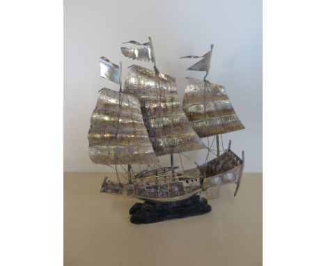 A white metal war junk model on stand 24cm tall 