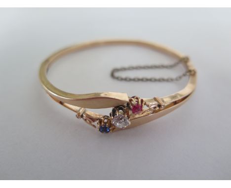 A yellow gold bracelet with a central diamond sapphire and ruby  - diamond approx 0.30ct - total weight approx 7.3 grams - no