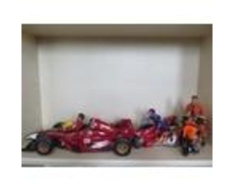 An Action man Formula 1 racing car, two motorbikes and three figures 