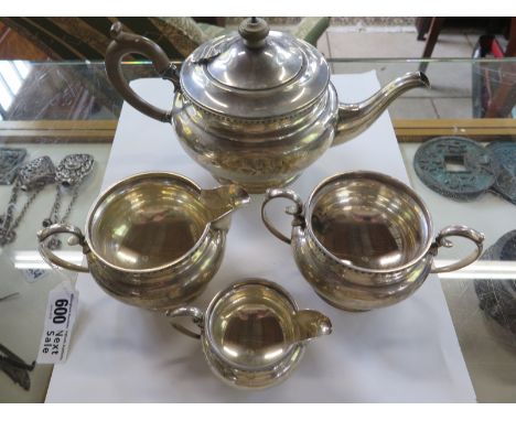 A silver teapot, a sugar bowl, milk jug and cream jug, hallmarked London 1911, some dents and signs of wear throughout, appro