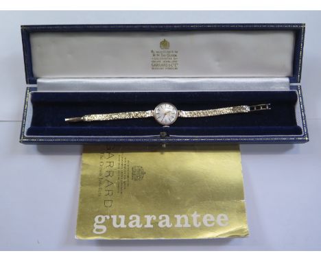 A Vintage 9ct yellow gold Garrard ladies bracelet wristwatch, 21mm wide including button - 16cm long, in clean working condit