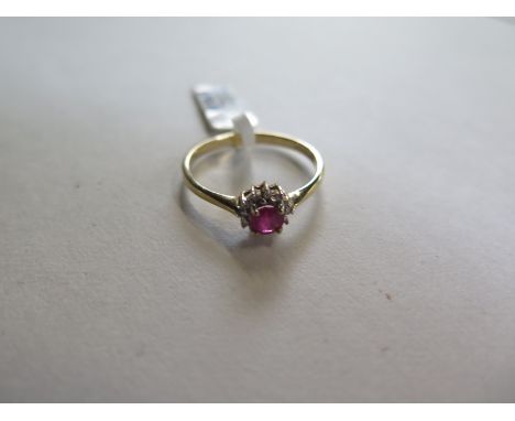 A hallmarked 9ct yellow gold ruby and diamond cluster ring - size O, approx 1.3 grams - ex jewellers stock, in as new conditi