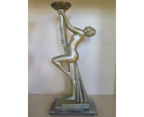 An Art deco style lamp base with female nude holding up lamp support, raised upon a chrome metal base without globe and with 