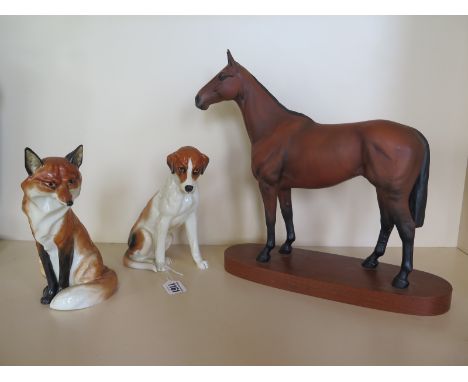 A Beswick figurine of the racehorse Arkle, approximately 30 cm tall together with two Royal Worcester animal figurines, a Fox