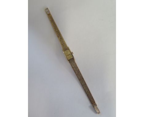 A 9ct yellow gold hallmarked Accurist ladies watch, manual wind, some spotting to dial - minor wear, running in sale room - t