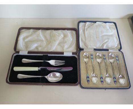 A boxed set of six silver and enamel spoons - Birmingham 1933/34 and a boxed christening set with silver fork and spoon - tot