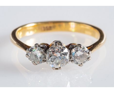 A three stone ring, set with old round-cut diamonds in a claw setting, diamonds approx. 1.00 carats total, marked 18ct, size 