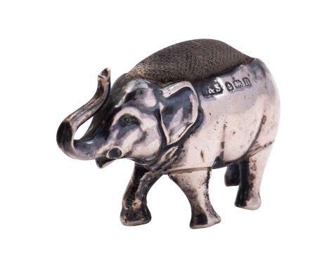 A silver novelty elephant pin cushion probably by Gilbert & Spurrier, Birmingham 1912, with a raised trunk, 11g, 4.5cm (1 3/4