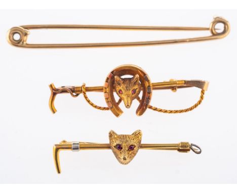 A group of three brooches, including a fox head, horseshoe & riding crop brooch, marked 15ct, length approx. 4.0cm, 3.5grams;