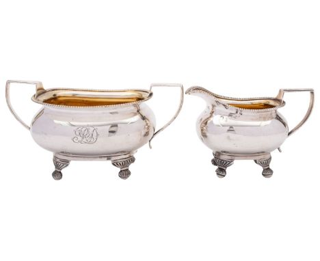 A George III silver sugar basin and milk jug, markers marks not struck, London 1811, of baluster form, gadrooned rim, reeded 