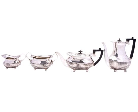 A George V silver four piece silver tea and coffee service by William Hutton & Sons Ltd, London 1910, of barge shape, with ga