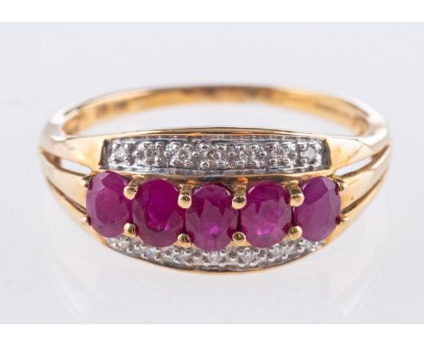 A 9ct yellow gold ruby & diamond ring, with a row of five oval-cut rubies and seven single-cut diamonds set to each side in a