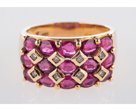 A ruby & diamond ring, a wide band set with three rows of oval-cut rubies, interspaced by eight brilliant-cut diamonds, rubie