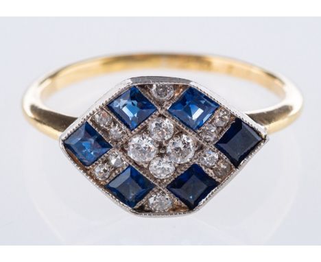 An Art Deco plaque ring, set with old European cut diamonds and step-cut synthetic sapphires in a geometric design, unmarked 