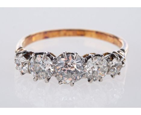 A five stone ring, with scroll engraved shoulders set with five old European cut diamonds in a claw setting, diamonds approx.