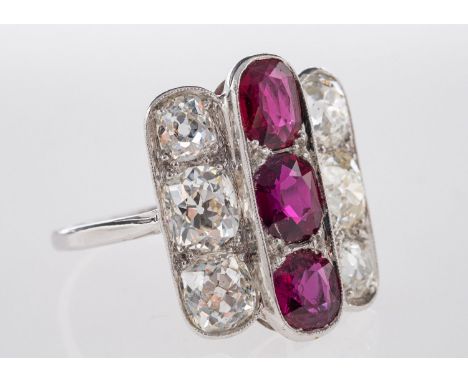 An Art Deco Ruby & Diamond Ring, a geometric designed three row ring, set to the centre with three oval-cut rubies, rubies ap