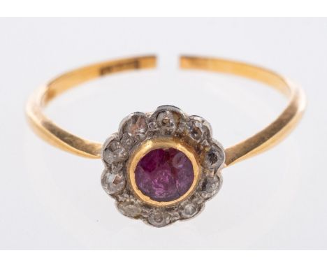 A flowerhead ring, set with a circular-cut ruby, surrounded by single-cut diamonds, marked 18ct, size N, 1.8grams.