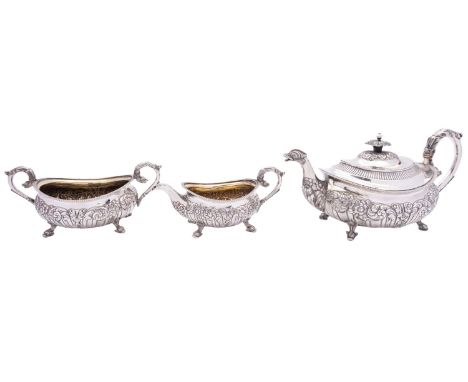 A George III silver three piece tea service by Robert Hennell II, London 1816, barge shape, the square foliate finial above a