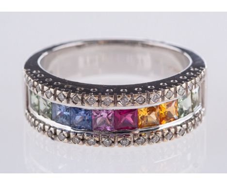 An 18ct white gold multi-colour sapphire ring, centrally set with ten princess-cut multi-coloured sapphires, set each side wi