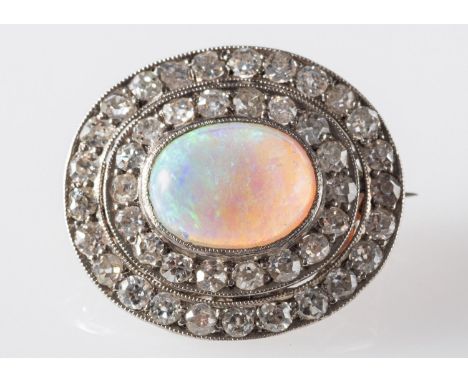 An opal and diamond brooch, set with an oval opal cabochon, surrounded by two rows of old-cut diamonds in a milgrain & claw s