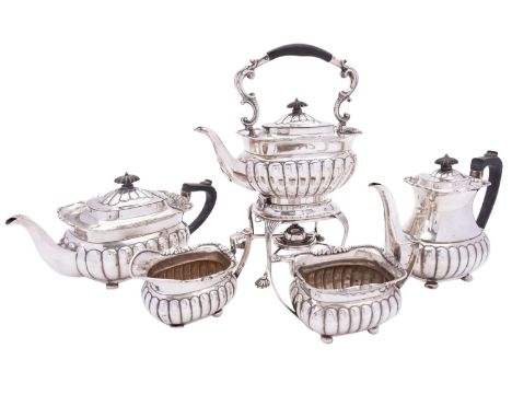 A George V five piece silver tea and coffee service by Mappin & Webb, London 1915, barge shape, part reeded, with scroll ebon