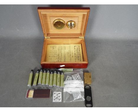 A vintage Dupont cigarette lighter with a quantity of accessories and a cigar humidor.