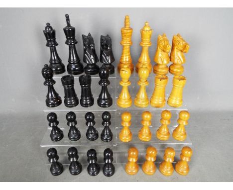 A carved wooden chess set with 16 cm king.