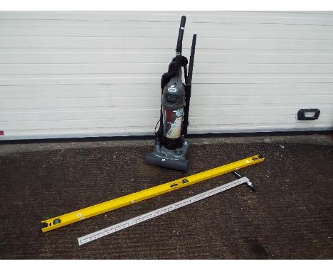 A Vax Turbo Force Ultra 1850 watt vacuum cleaner, a Betts Tools Builder's Level &amp; Angle Finder and a Tee Square. [3]