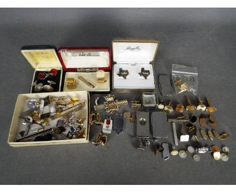 A collection vintage cufflinks, tie clips and similar.