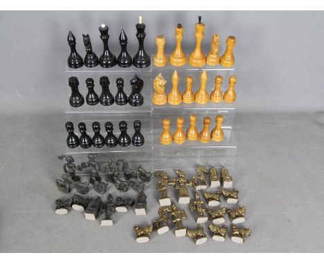 Two chess sets, a carved wooden example with 12 cm king and a cast metal set with 10 cm king. [3]