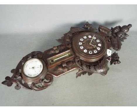 A Late 19th century decorative cartel style wall clock compendium, the case heavily carved with Rococo scrolls, flora and fla
