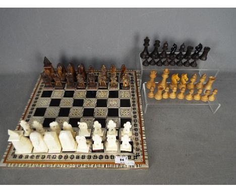 Two chess sets, one with Egyptian style pieces (10 cm king), the other Staunton style with 8 cm king, also includes decorativ