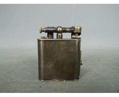 A vintage Dunhill cigarette lighter.